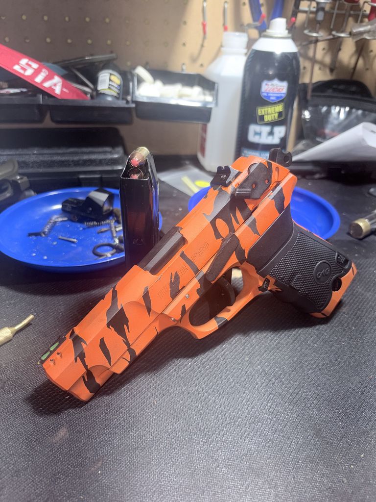 Pistol Cerakoted in an orange and black Tiger Stripe pattern by Standard Issue Armory